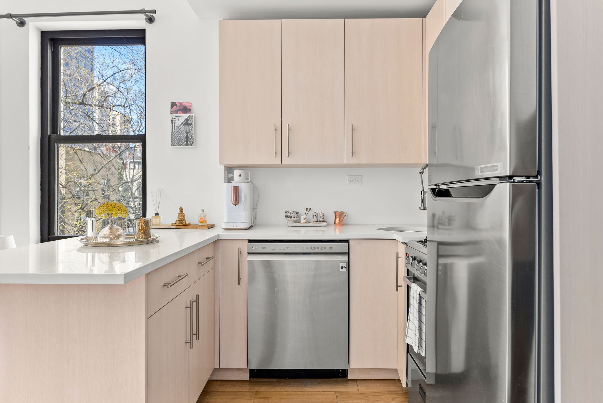 512 East 83rd Street, Unit D4 Manhattan, NY 10028 - Photo 10 of 21 a kitchen with stainless steel appliances granite countertop a sink a stove and a refrigerator