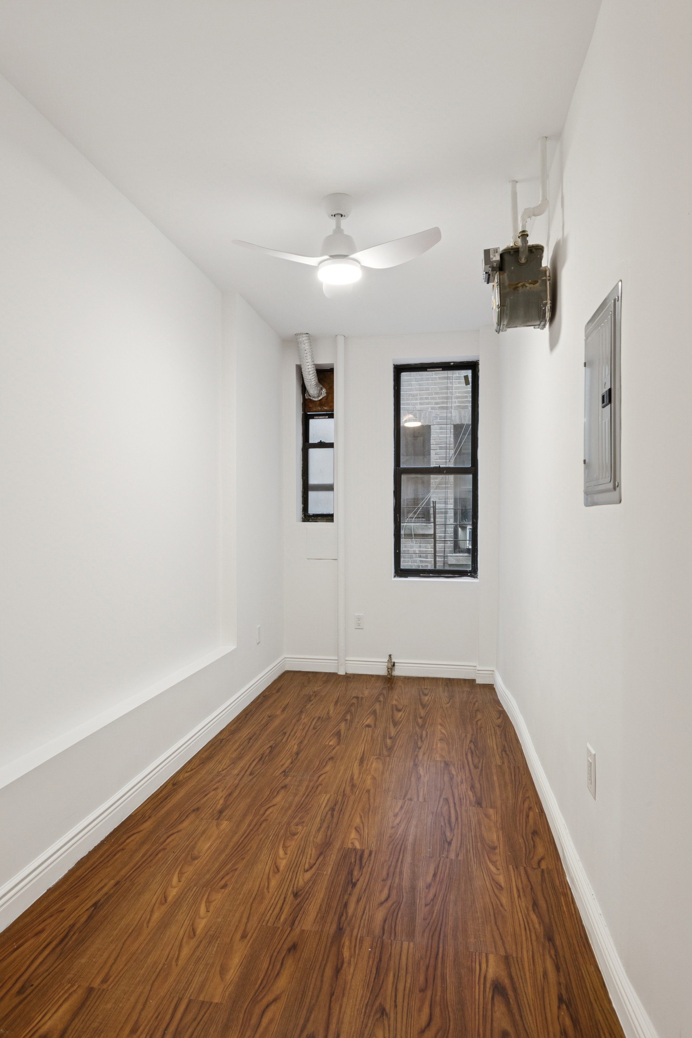 804 West 180th Street, Unit 41 Manhattan, NY 10033 - Photo 15 of 23 an empty room with windows and cabinet