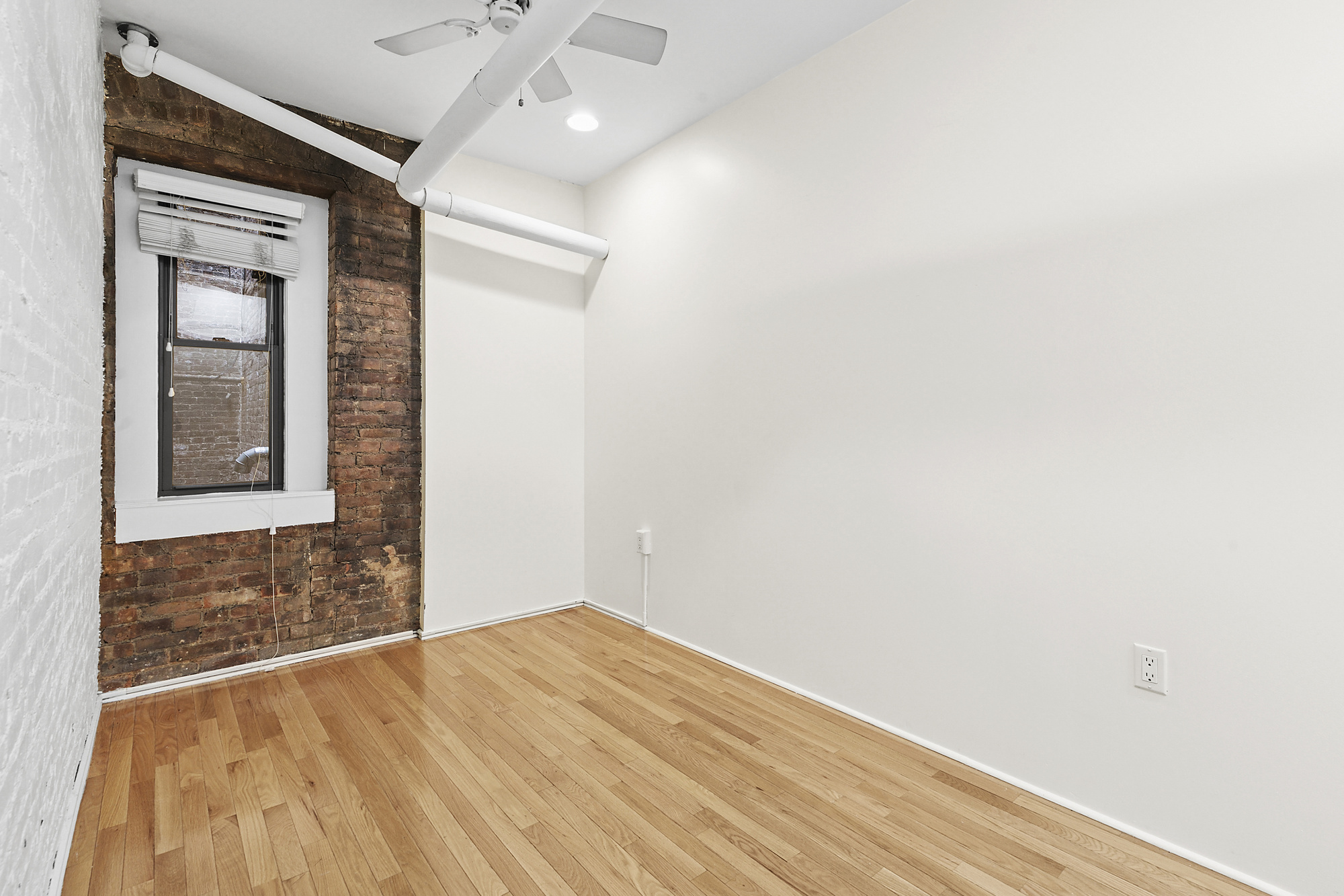 140 West 10th Street, Unit BTE Manhattan, NY 10014 - Photo 4 of 12 a view of empty room with wooden floor and fan