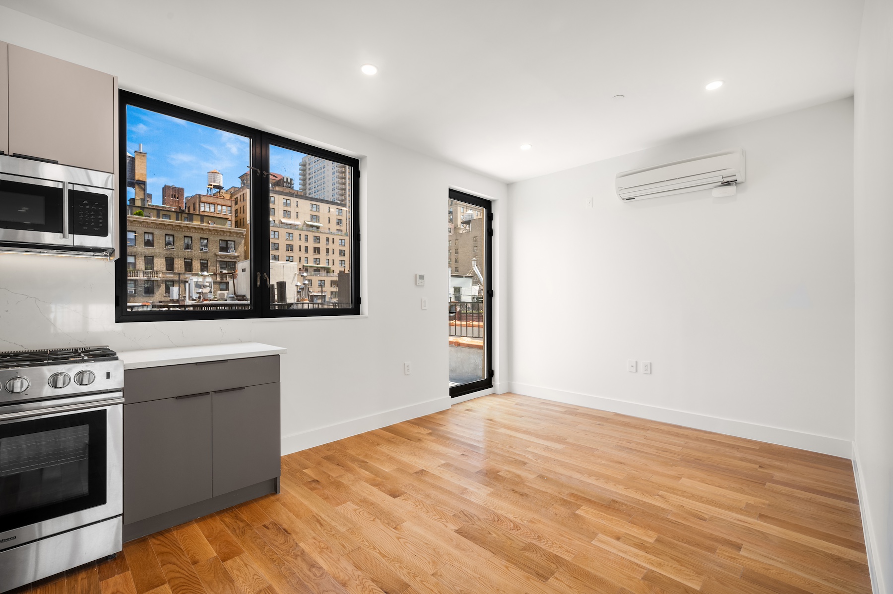 61 West 70th Street, Unit PH Manhattan, NY 10023 - Photo 7 of 18 a view of a kitchen with an empty room and wooden floor