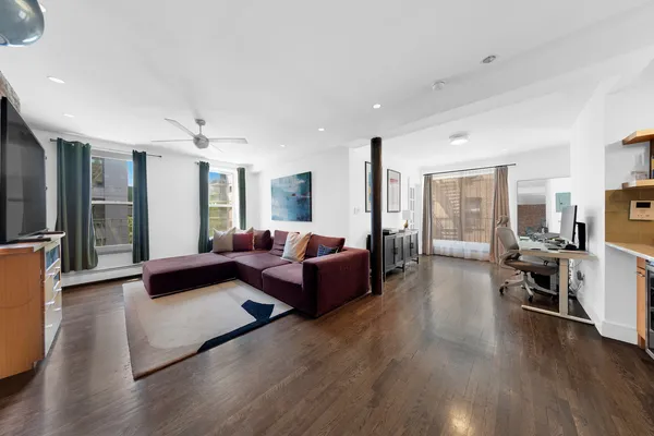 a living room with furniture and a large window