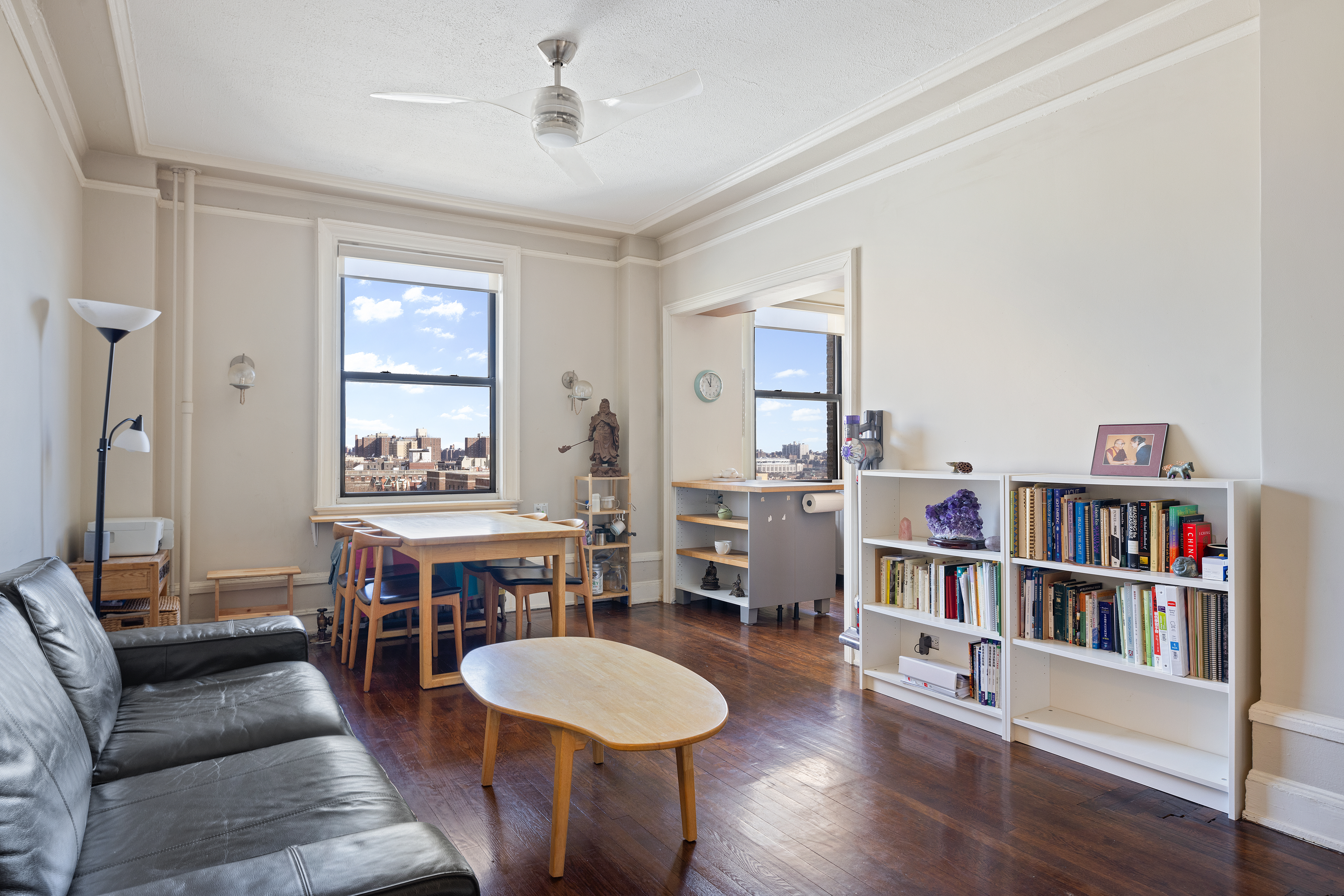 270 Convent Avenue, Unit 8B Manhattan, NY 10031 - Photo 3 of 10 a living room with furniture and a book shelf