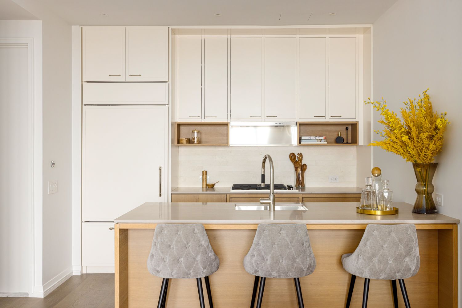 250 West 96th Street, Unit 22E Manhattan, NY 10025 - Photo 4 of 27 a kitchen with kitchen island granite countertop a table and chair in it