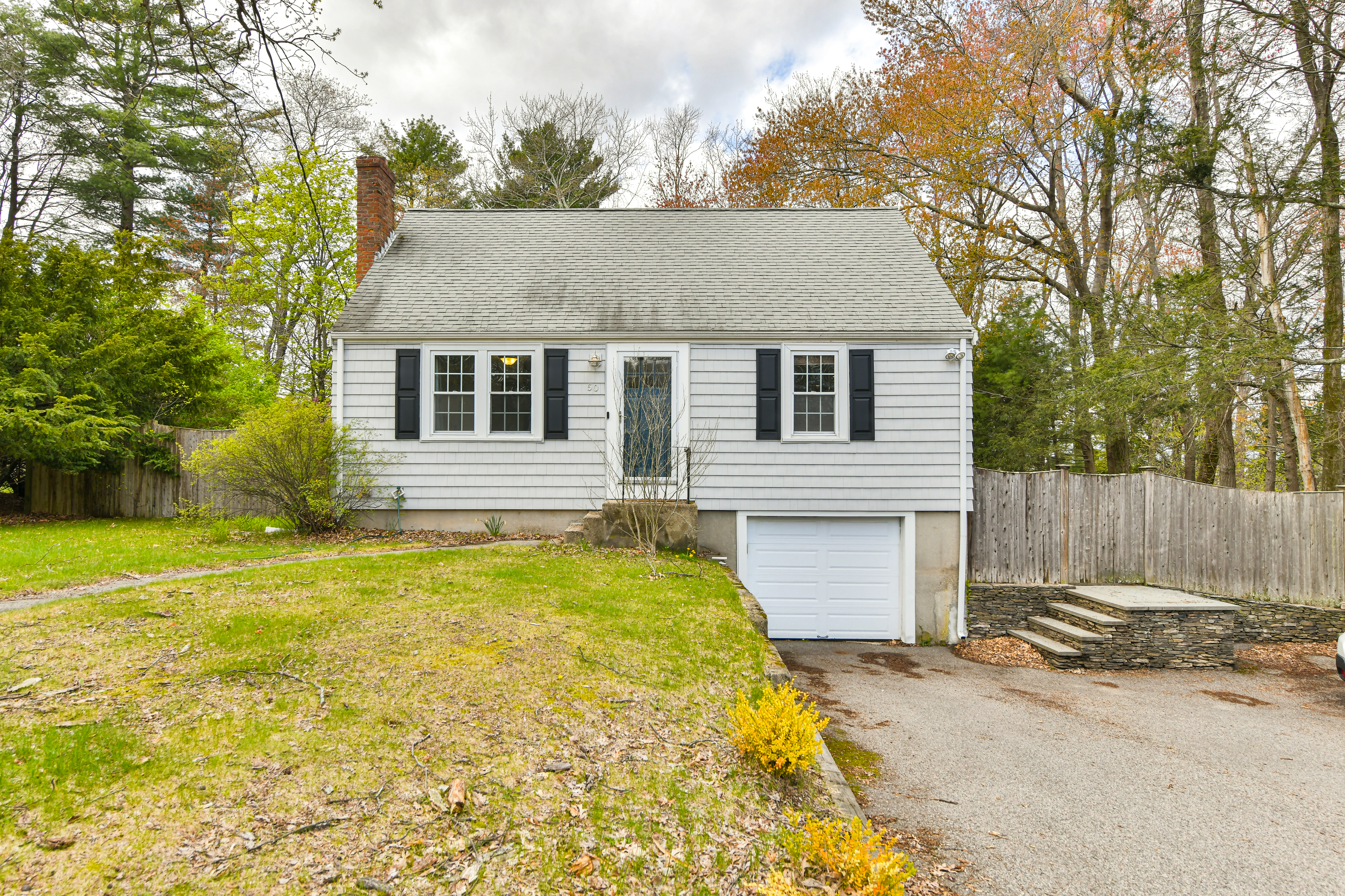 50 Rustic Road Walpole, MA 02032 - Photo 10 of 16 a front view of a house with a yard and garage