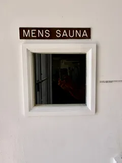 a sign that is sitting in front of a wall