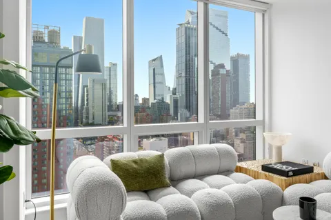 a balcony with furniture and a large window