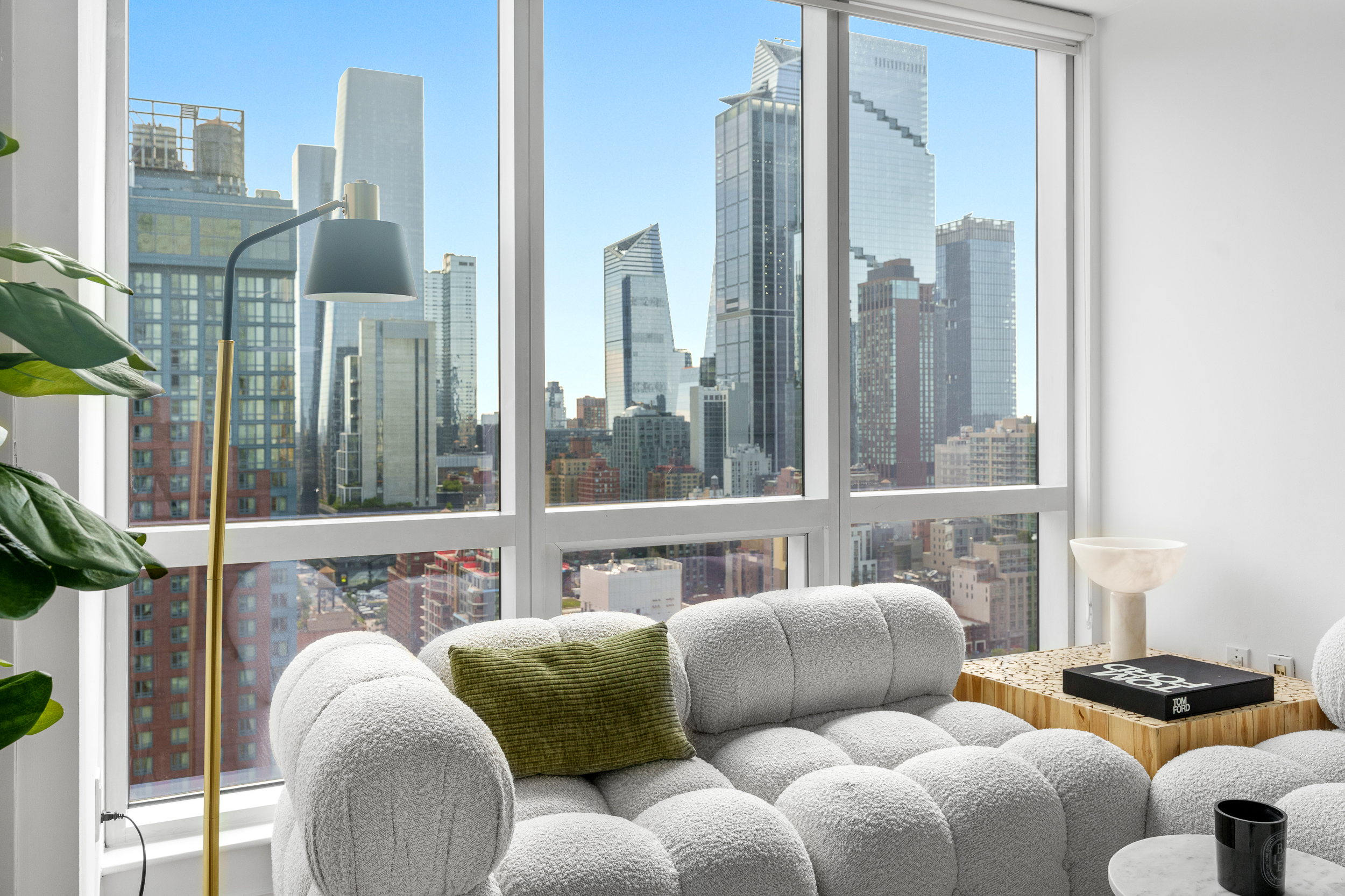 350 West 42nd Street, Unit 27K Manhattan, NY 10036 - Photo 4 of 18 a balcony with furniture and a large window