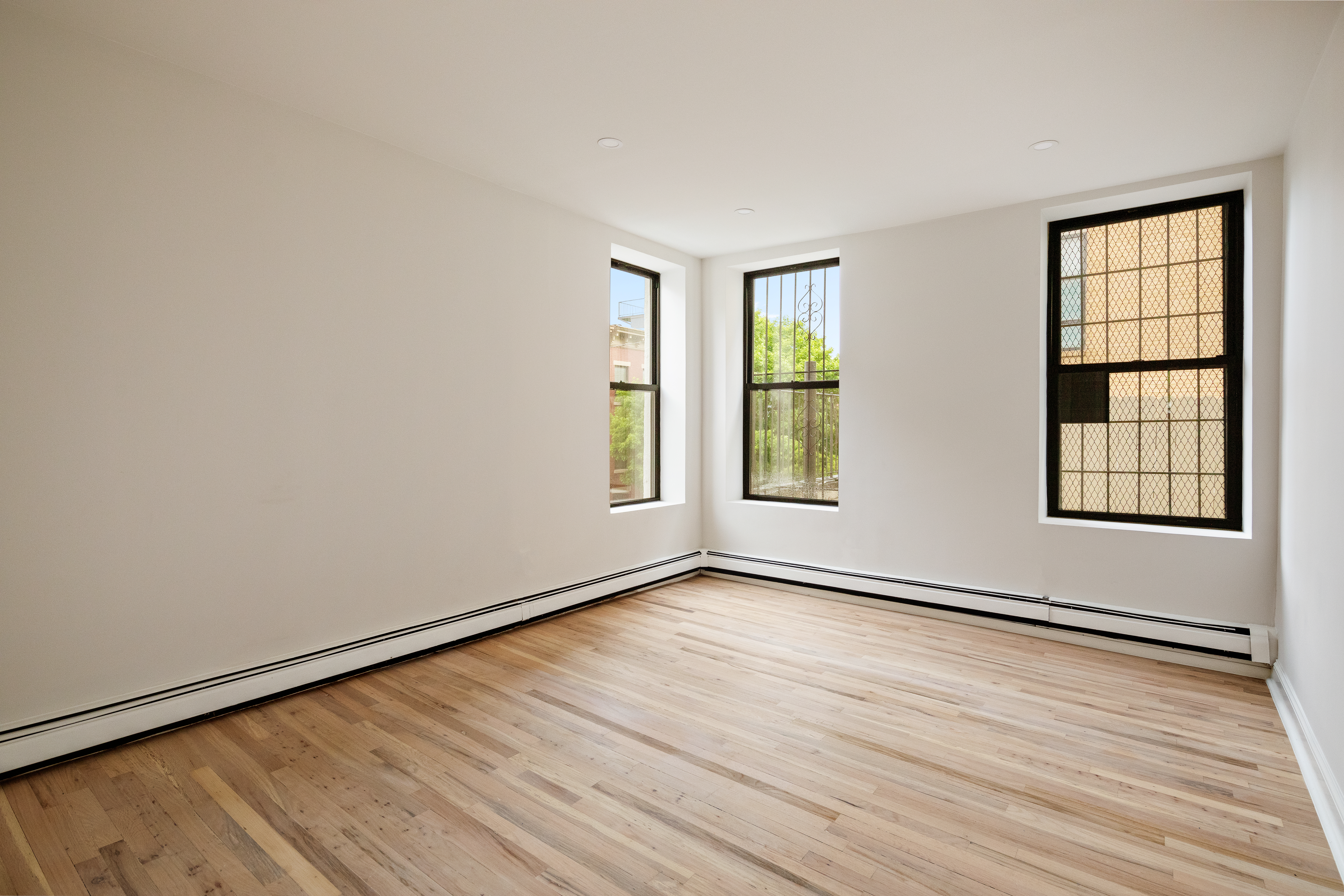 544 Court Street, Unit 2 Brooklyn, NY 11231 - Photo 5 of 9 an empty room with wooden floor and windows
