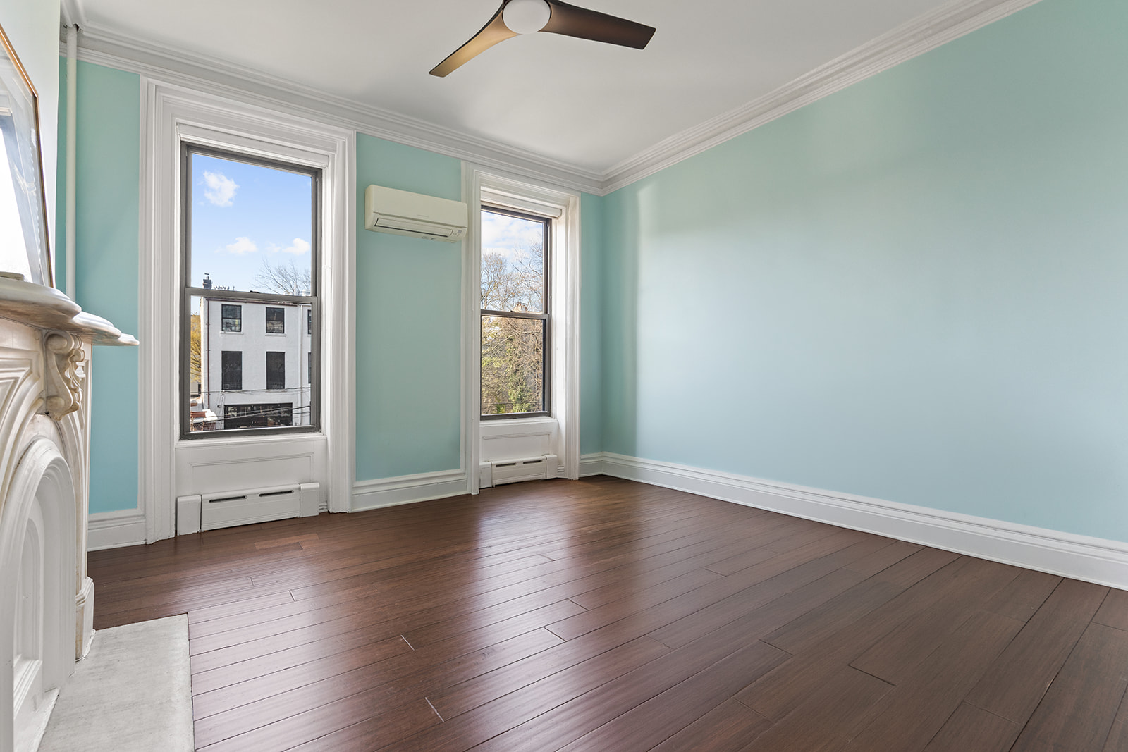 50 Wyckoff Street, Unit 2 Brooklyn, NY 11201 - Photo 10 of 14 an empty room with wooden floor a ceiling fan and windows