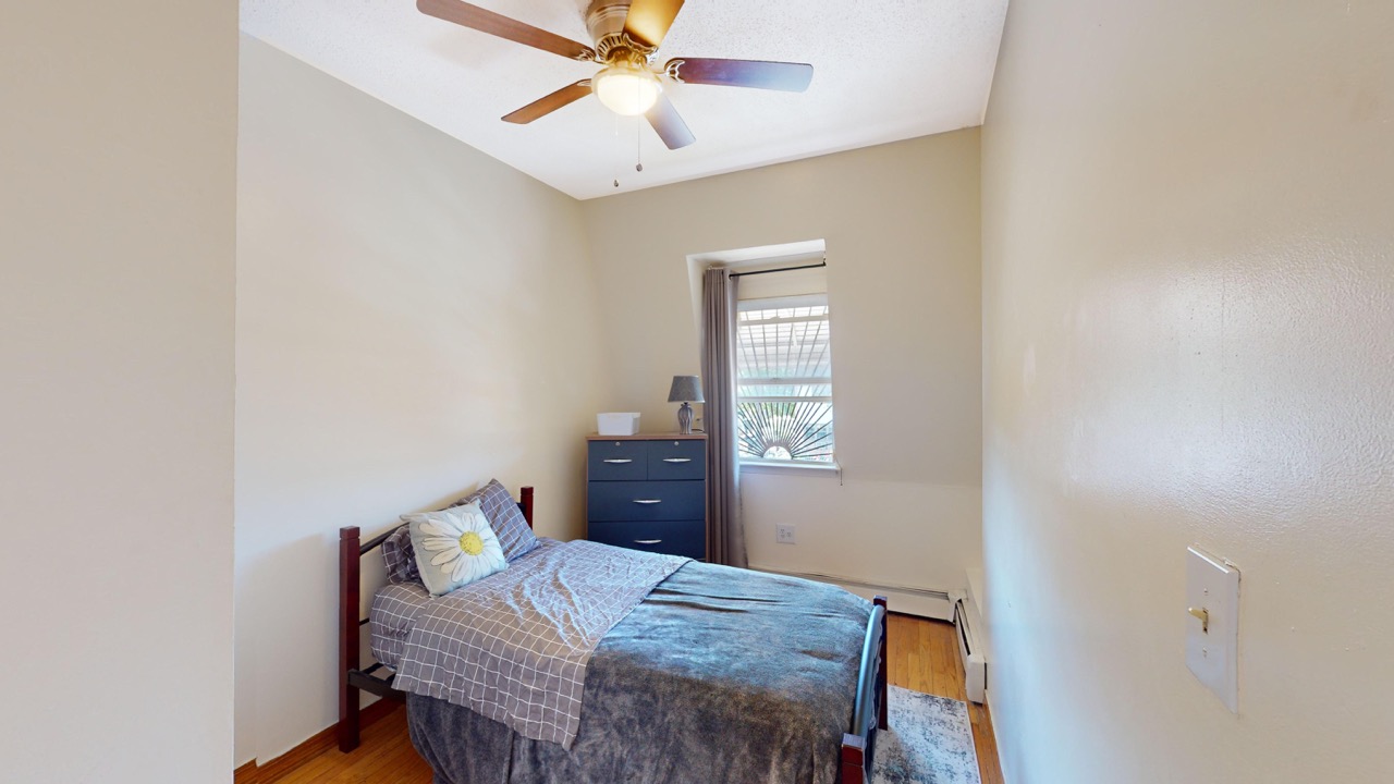 495 Central Avenue, Unit 2 Brooklyn, NY 11221 - Photo 13 of 19 a bedroom with a bed and a chandelier