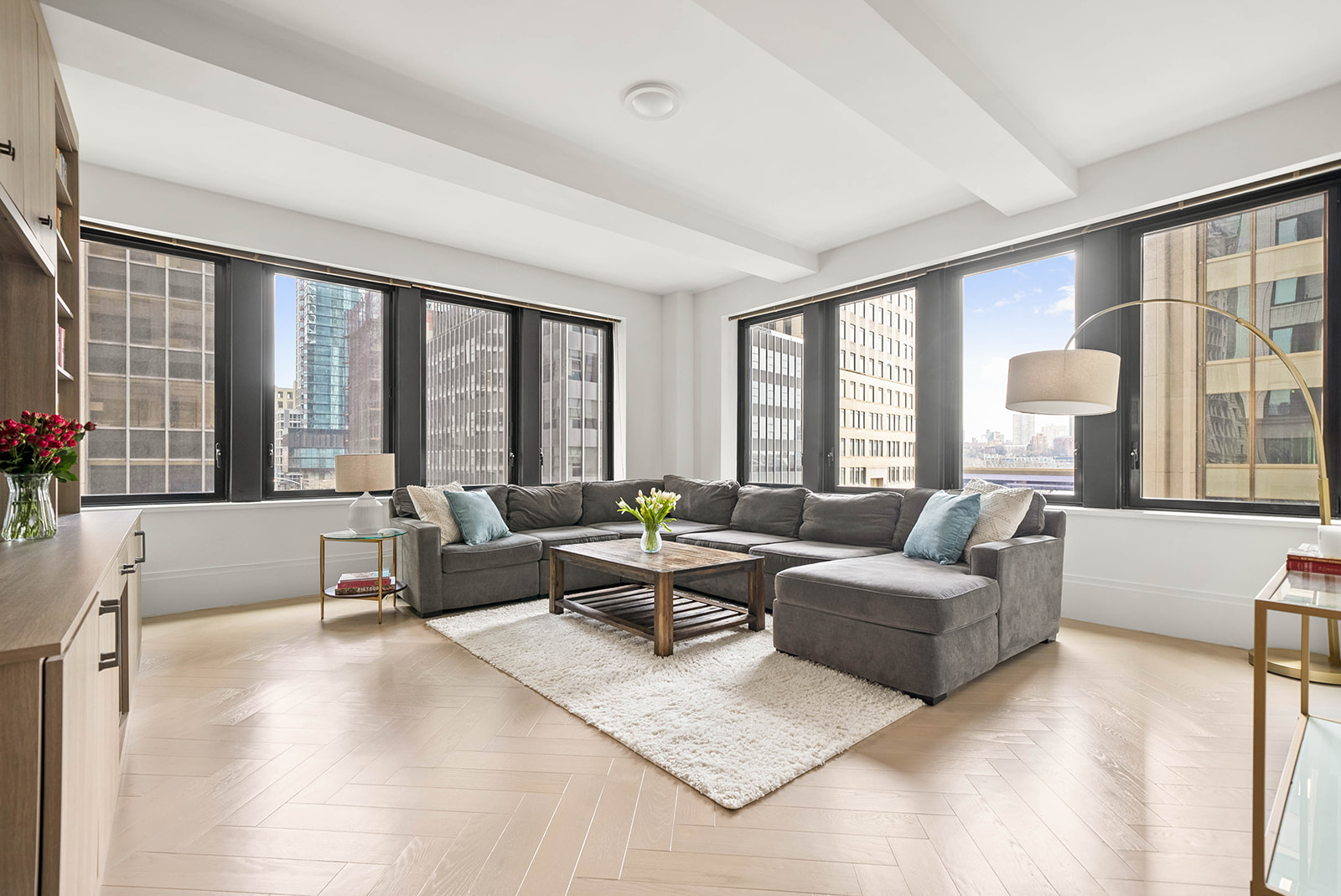 101 Wall Street, Unit 4B Manhattan, NY 10005 - Photo 1 of 20 a living room with furniture and large windows