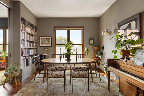 a view of a dining room with furniture window and wooden floor