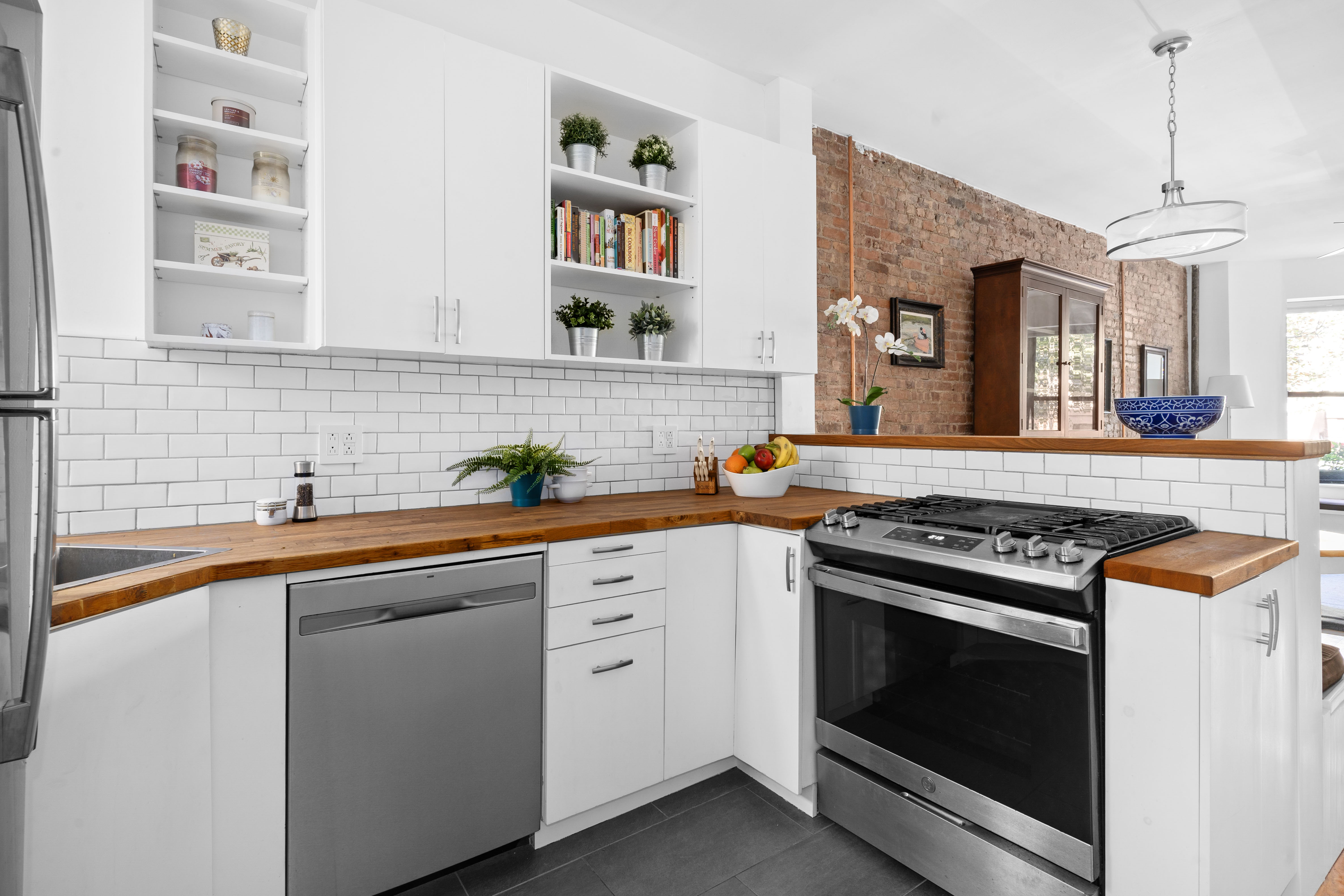 456 15th Street, Unit 1R Brooklyn, NY 11215 - Photo 4 of 14 a kitchen with cabinets stainless steel appliances and wooden floor