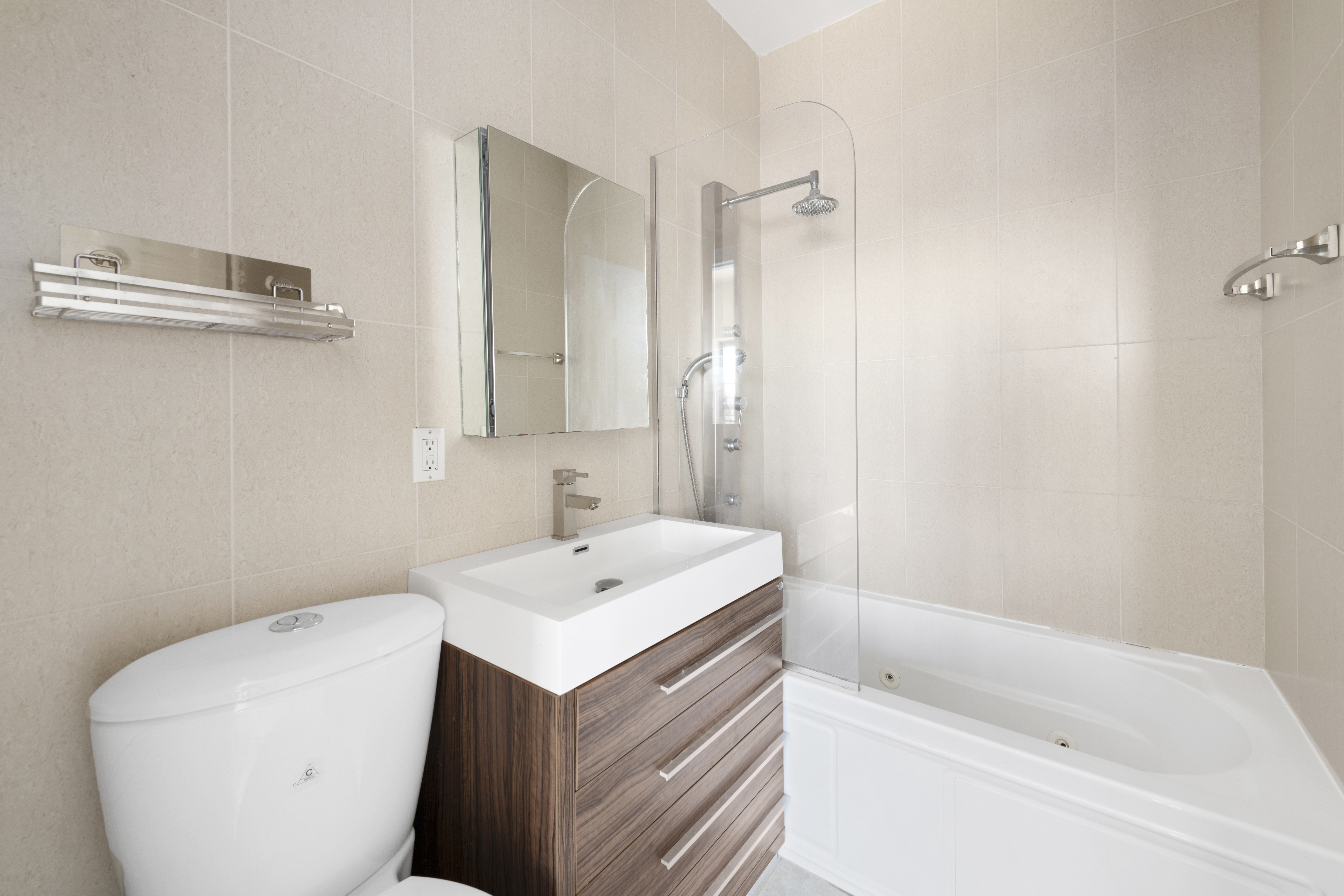 221 Troutman Street, Unit 4L Brooklyn, NY 11237 - Photo 9 of 11 a bathroom with a sink a toilet and shower