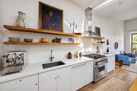 a kitchen with stainless steel appliances a stove a sink and cabinets