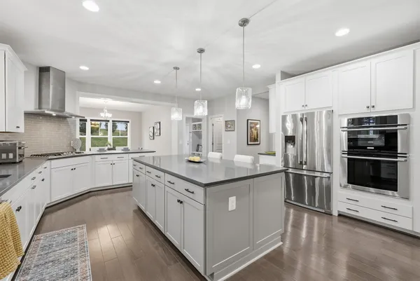 a kitchen with stainless steel appliances granite countertop a stove and a refrigerator