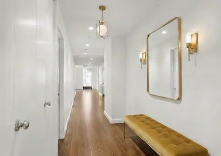 a view of hallway with wooden floor
