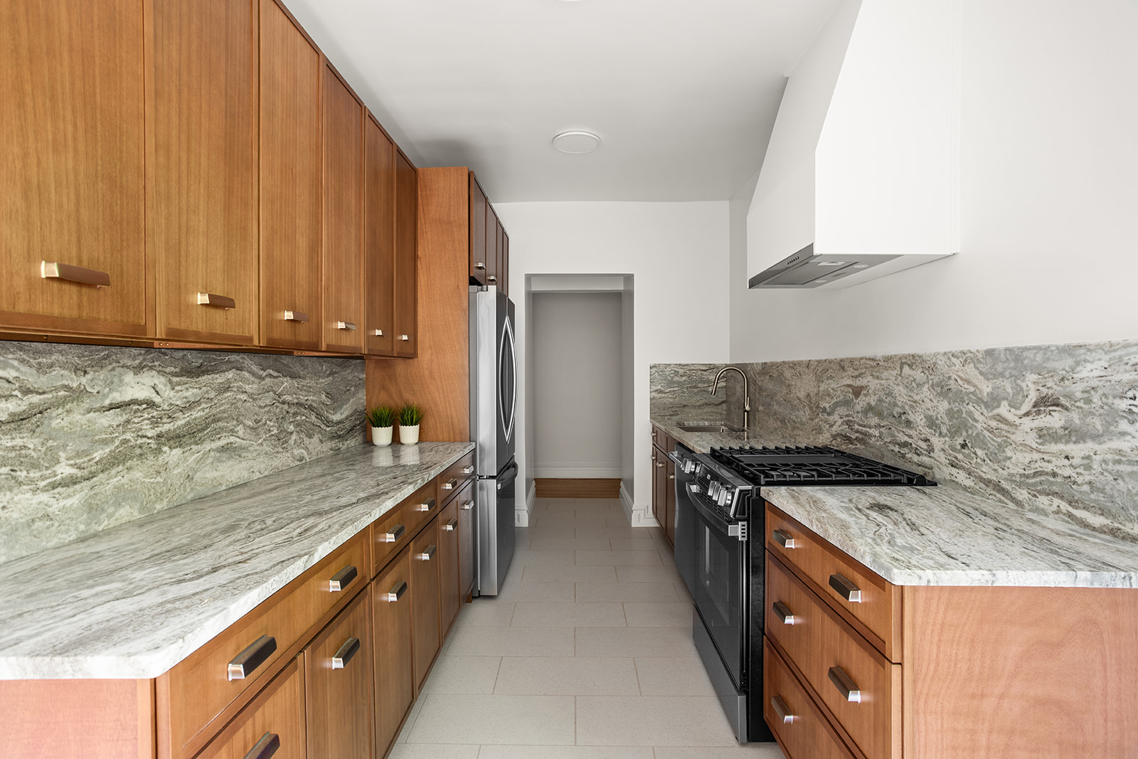 83-10 35th Avenue, Unit 3F Queens, NY 11372 - Photo 3 of 13 a kitchen with granite countertop a sink and a stove