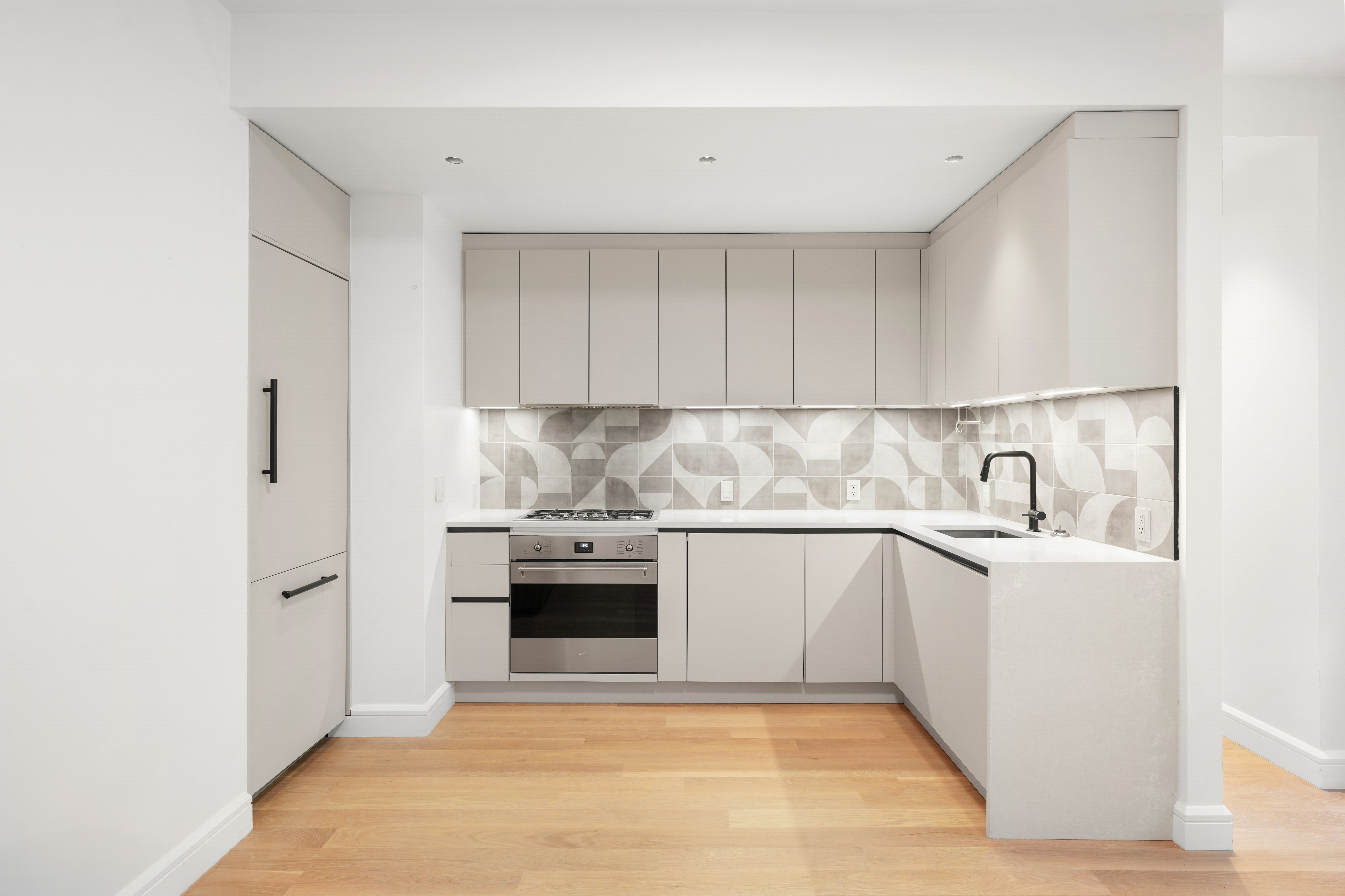 176 West 87th Street, Unit 1H Manhattan, NY 10024 - Photo 4 of 19 a view of kitchen with stainless steel appliances granite countertop a sink and dishwasher a stove with wooden floor