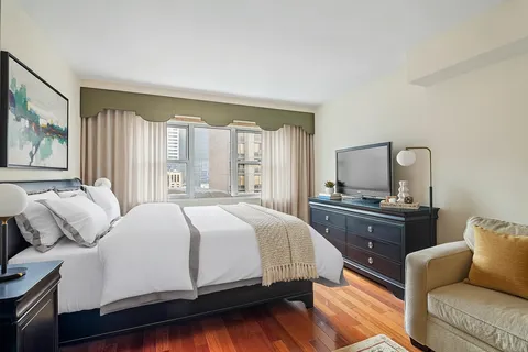 a bedroom with a large bed and a couch