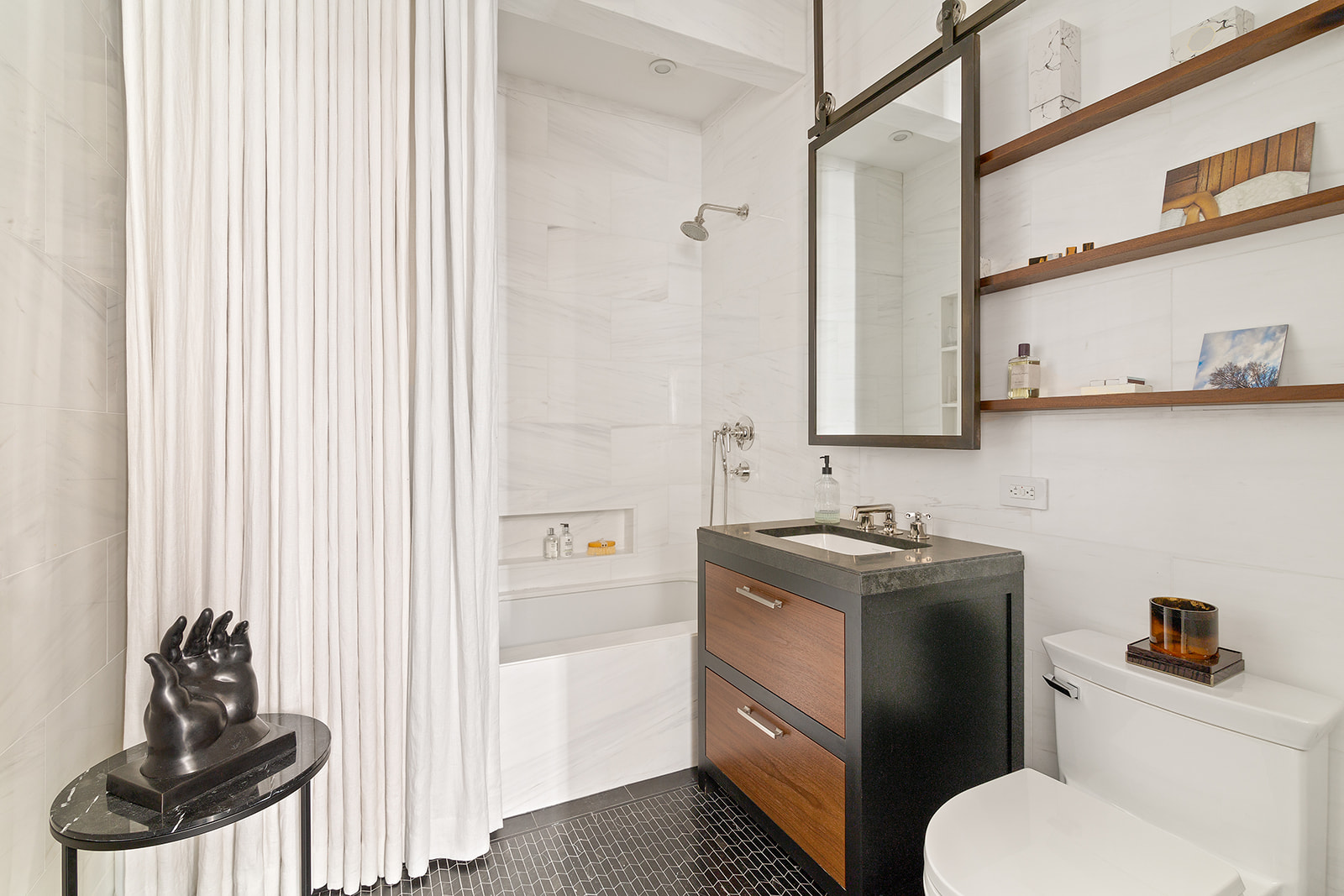 212 West 18th Street, Unit 9C Manhattan, NY 10011 - Photo 9 of 10 a bathroom with a toilet sink and mirror