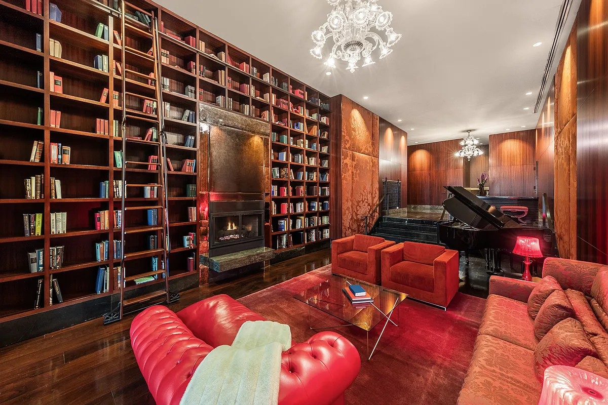 88 Greenwich Street, Unit 1025 Manhattan, NY 10006 - Photo 12 of 14 a living room with furniture and a large book shelf