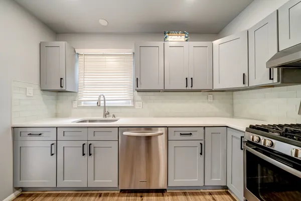 a kitchen with cabinets appliances and a window