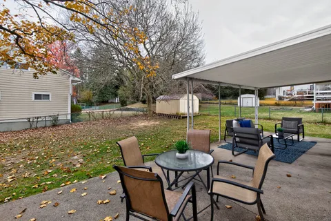 a view of a patio with a dining table and chairs with two couches
