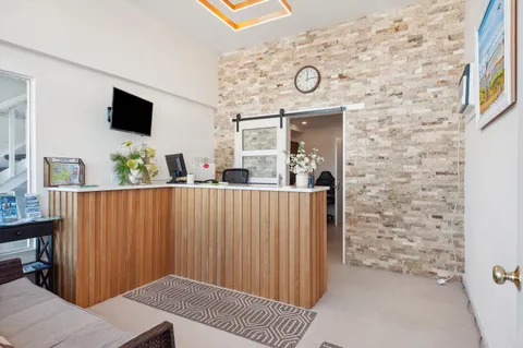 swimming pool view with a seating space