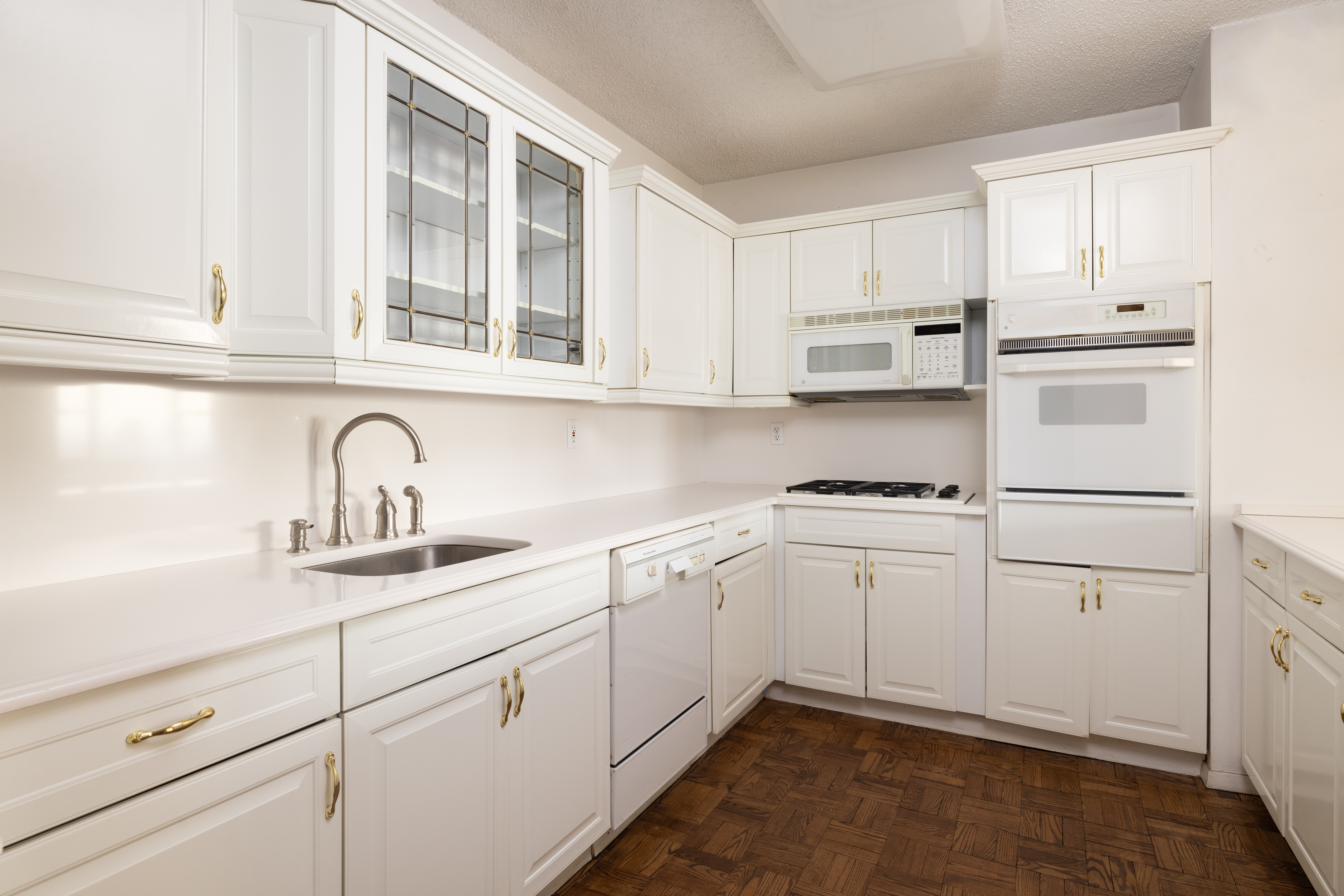20 West 64th Street, Unit 41H Manhattan, NY 10023 - Photo 10 of 39 a kitchen with appliances cabinets and a sink