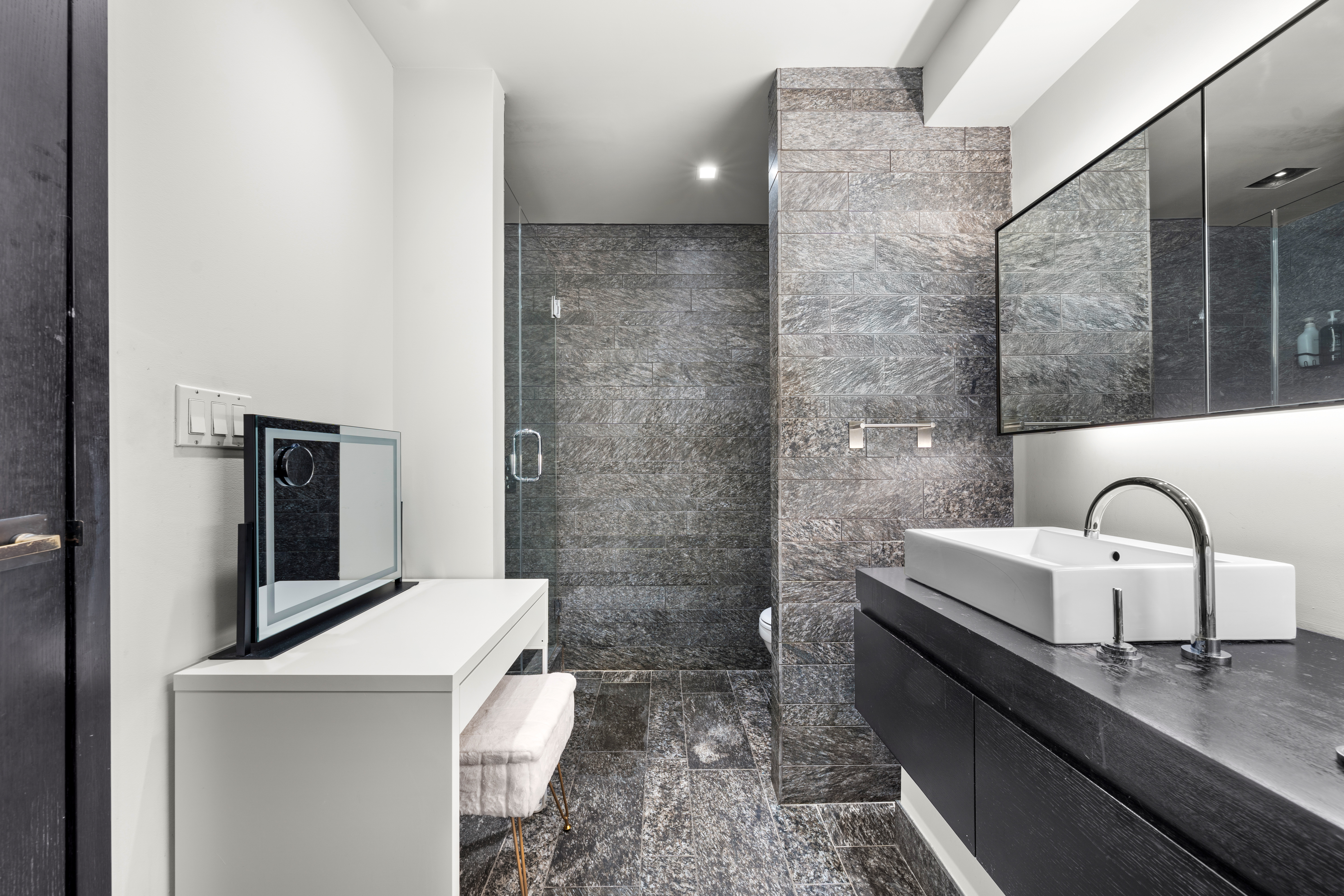 20 Pine Street, Unit 1205 Manhattan, NY 10005 - Photo 7 of 17 a bathroom with a sink and a mirror