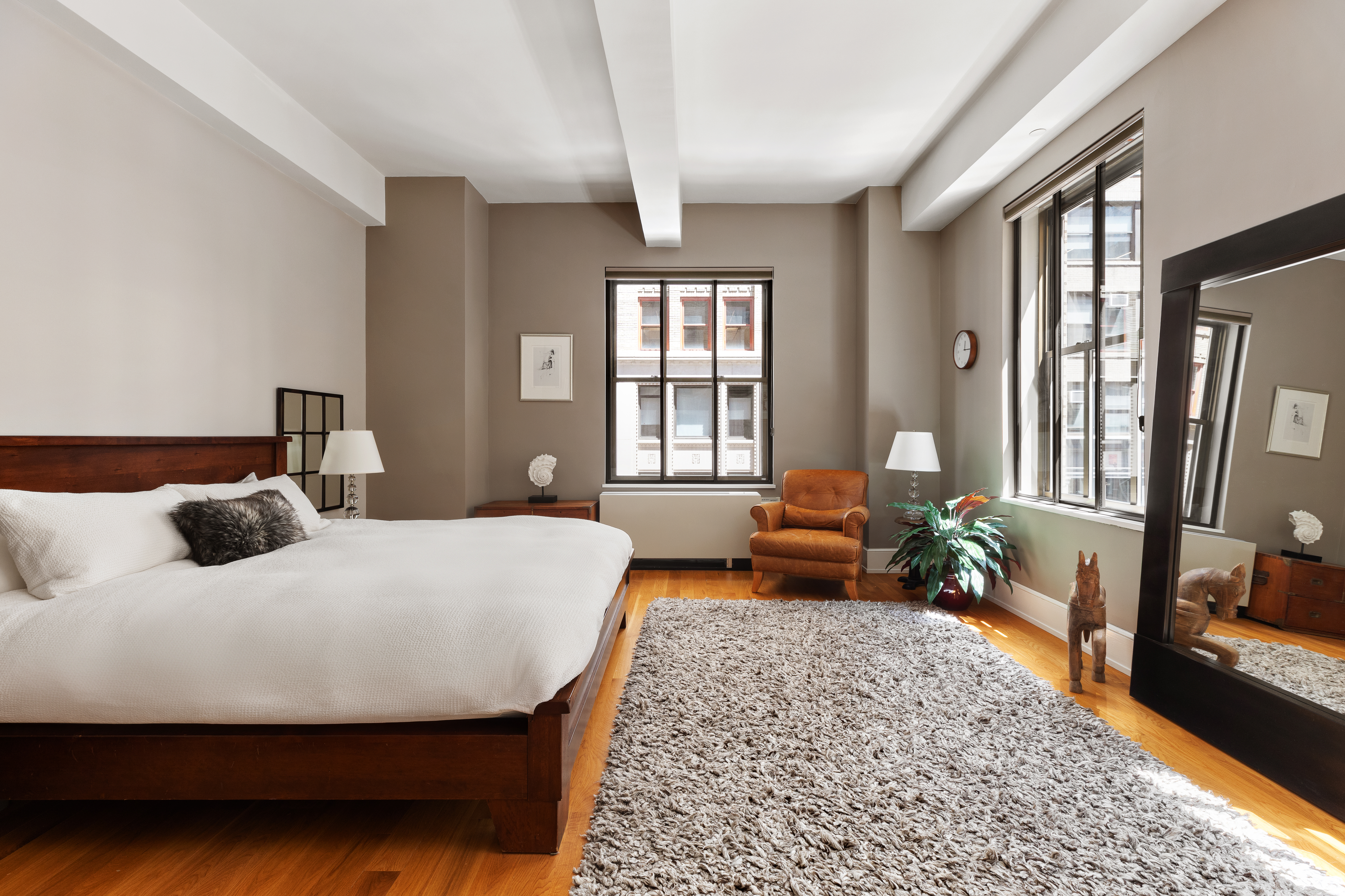 130 West 30th Street, Unit 3B Manhattan, NY 10001 - Photo 8 of 15 a bedroom with a bed and wooden floor