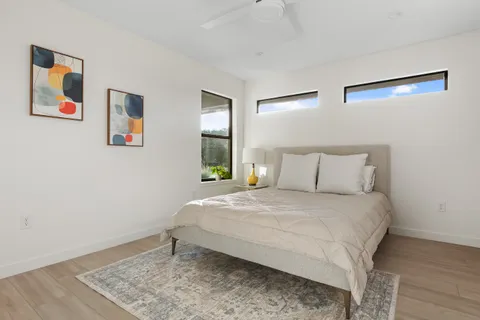 a bedroom with a bed and wooden floor
