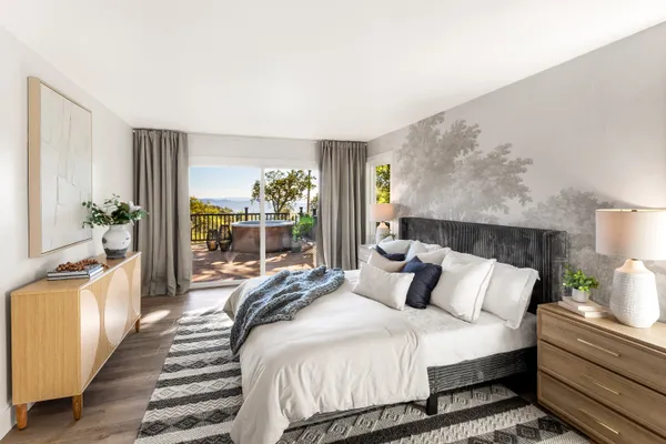 a bedroom with bed and wooden floor
