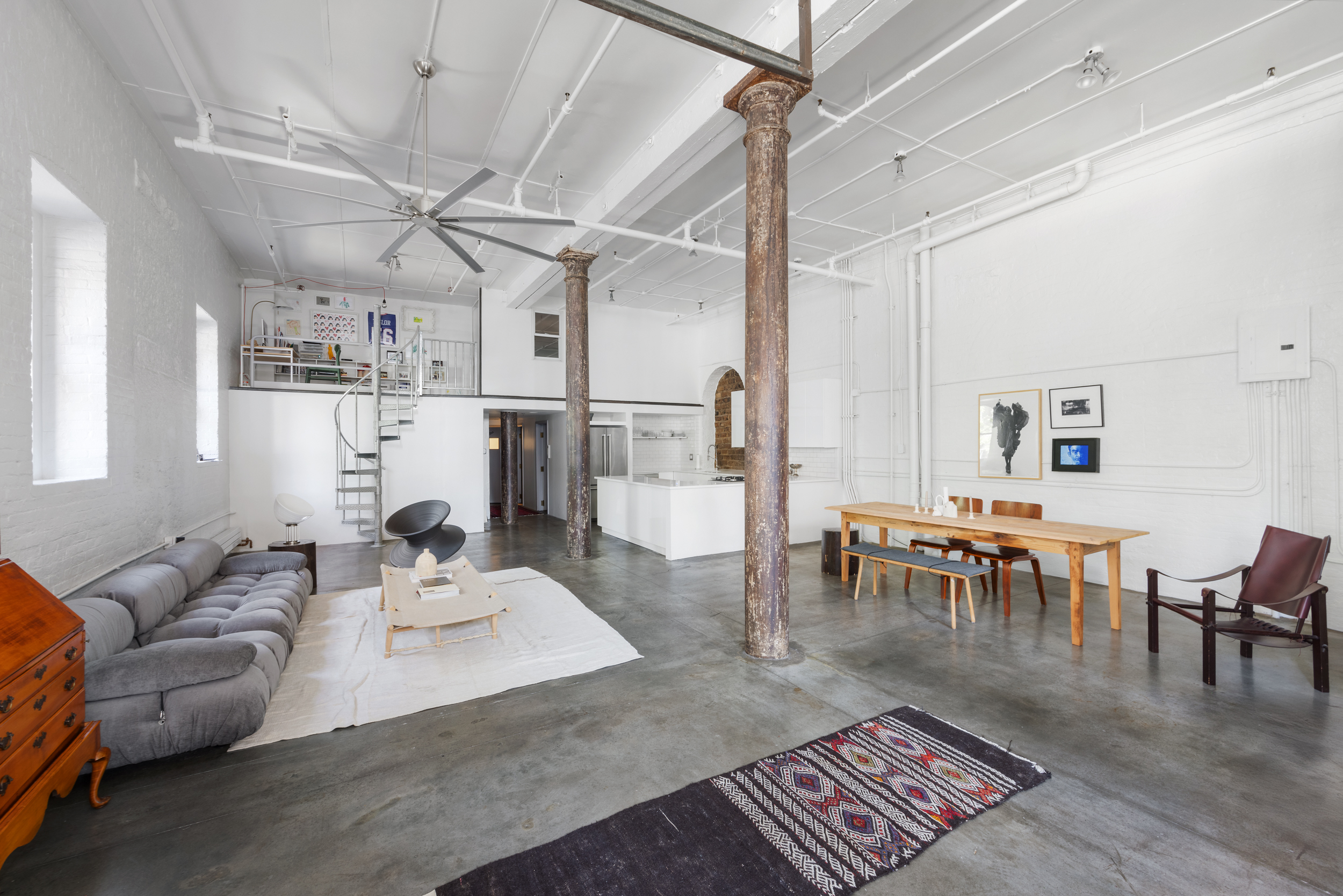 125 Watts Street, Unit 1 Manhattan, NY 10013 - Photo 6 of 24 a living room with furniture and a dining table with wooden floor