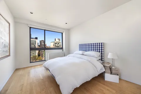 a spacious bedroom with a bed and a cabinets