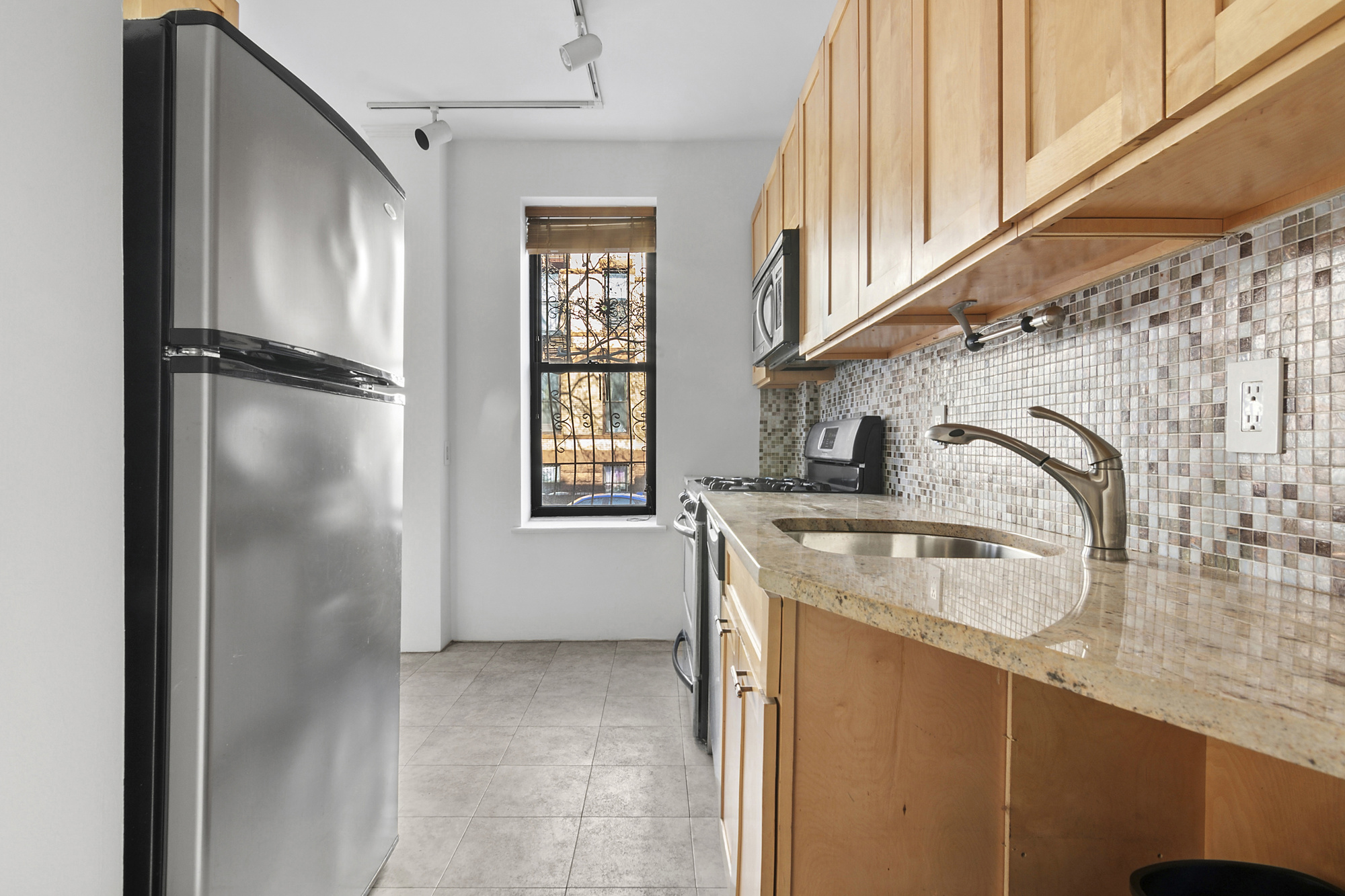 264 6th Avenue, Unit 1C Brooklyn, NY 11215 - Photo 5 of 11 a kitchen with a refrigerator and a sink