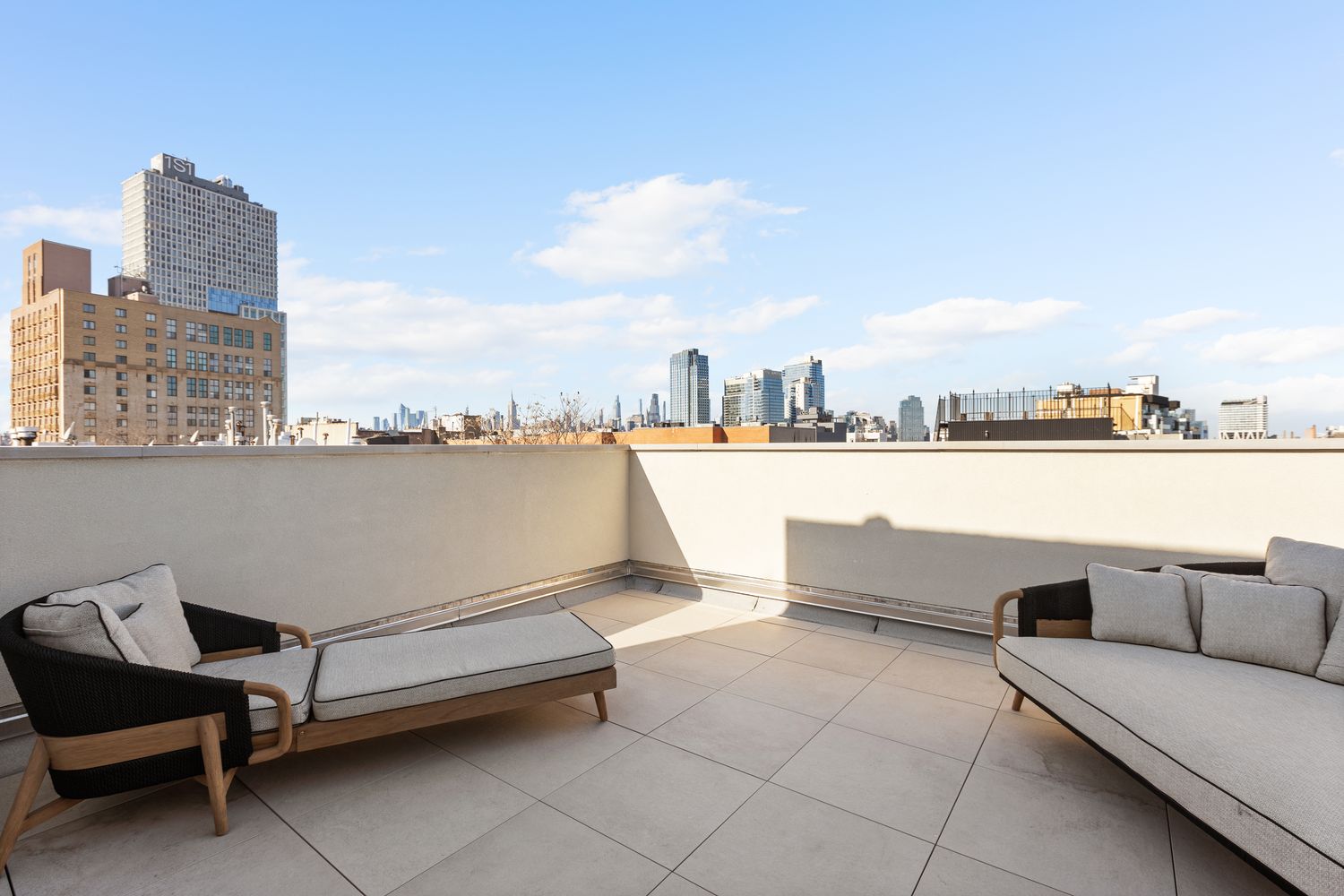a roof deck with couch and city view