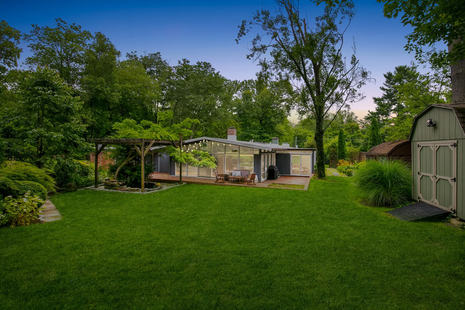 a backyard of a house with wooden floor yard and outdoor seating