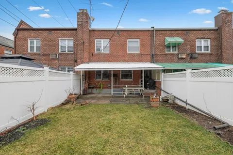 a view of a house with a yard and sitting area