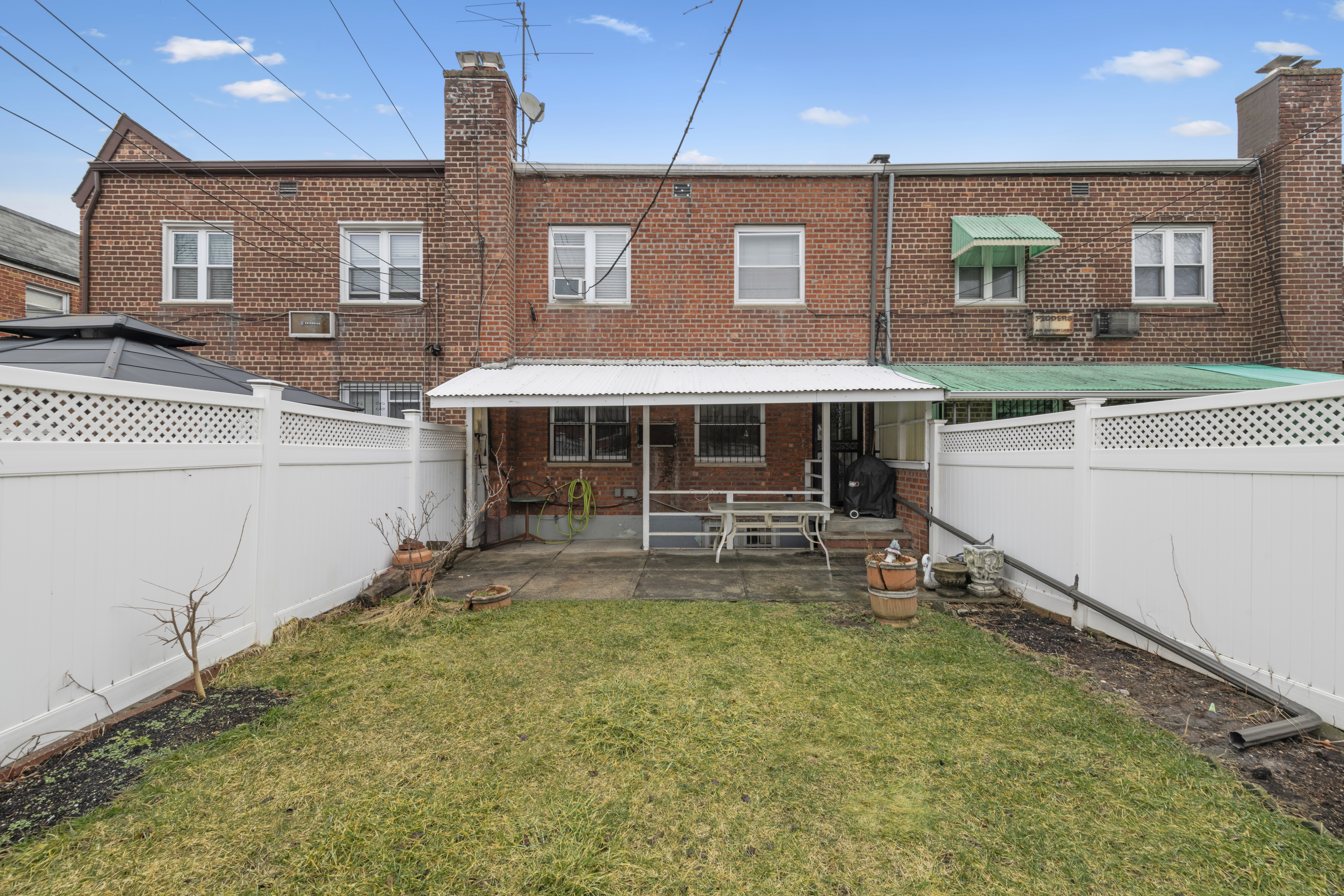 25-36 72nd Street Queens, NY 11370 - Photo 14 of 17 a view of a house with a yard and sitting area