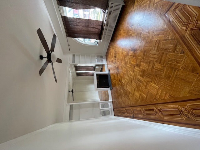 340 Marlborough Road Brooklyn, NY 11226 - Photo 6 of 27 a view of a livingroom with wooden floor and a ceiling fan