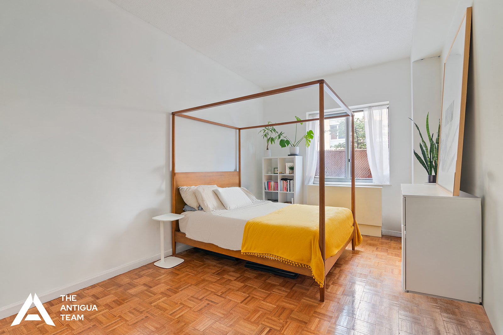 300 West 135th Street, Unit 2M Manhattan, NY 10030 - Photo 5 of 8 a bed sitting in a bedroom next to a window