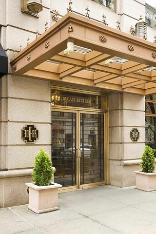 30 East 85th Street, Unit 8B Manhattan, NY 10028 - Photo 10 of 12 a view of a building with a potted plant