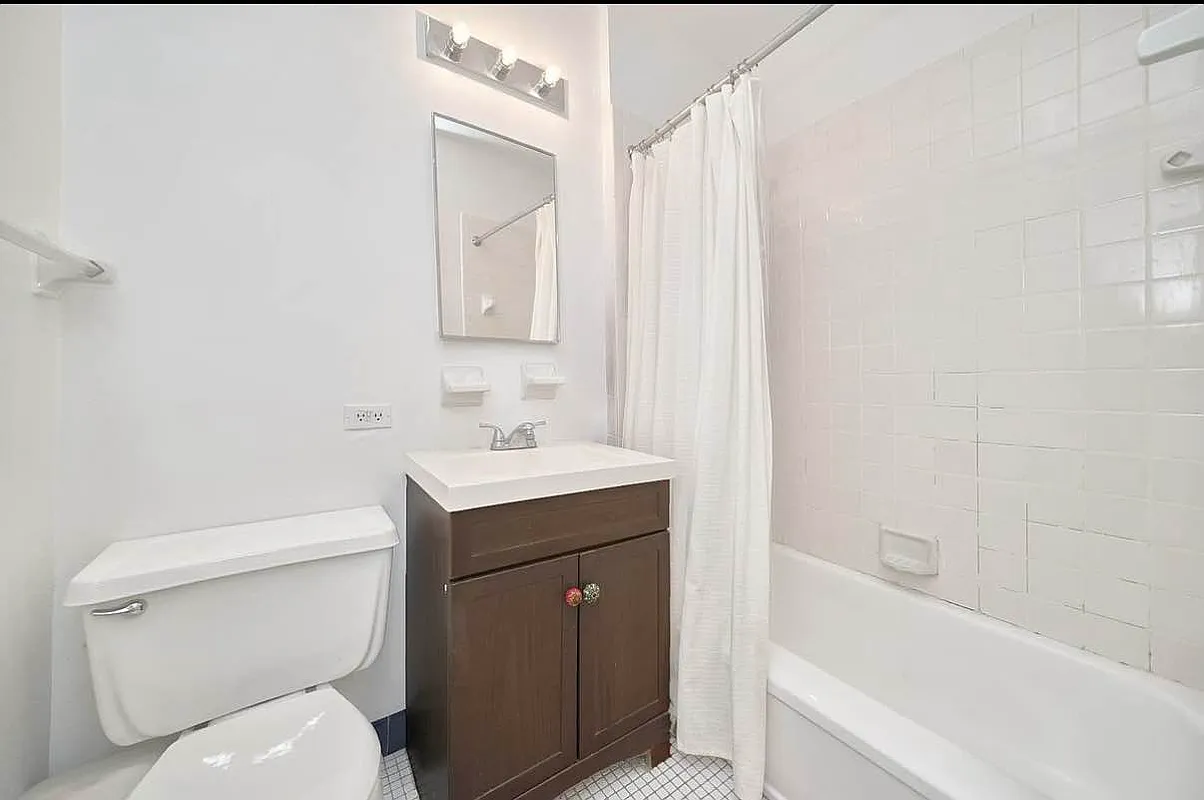 103 West 105th Street, Unit 2A Manhattan, NY 10025 - Photo 6 of 10 a bathroom with a sink toilet and shower