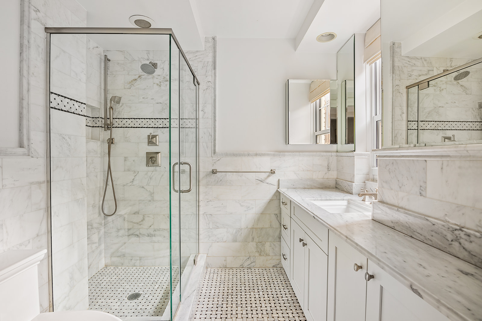 302 West 12th Street, Unit 5G Manhattan, NY 10014 - Photo 8 of 18 a spacious bathroom with a shower sink and mirror