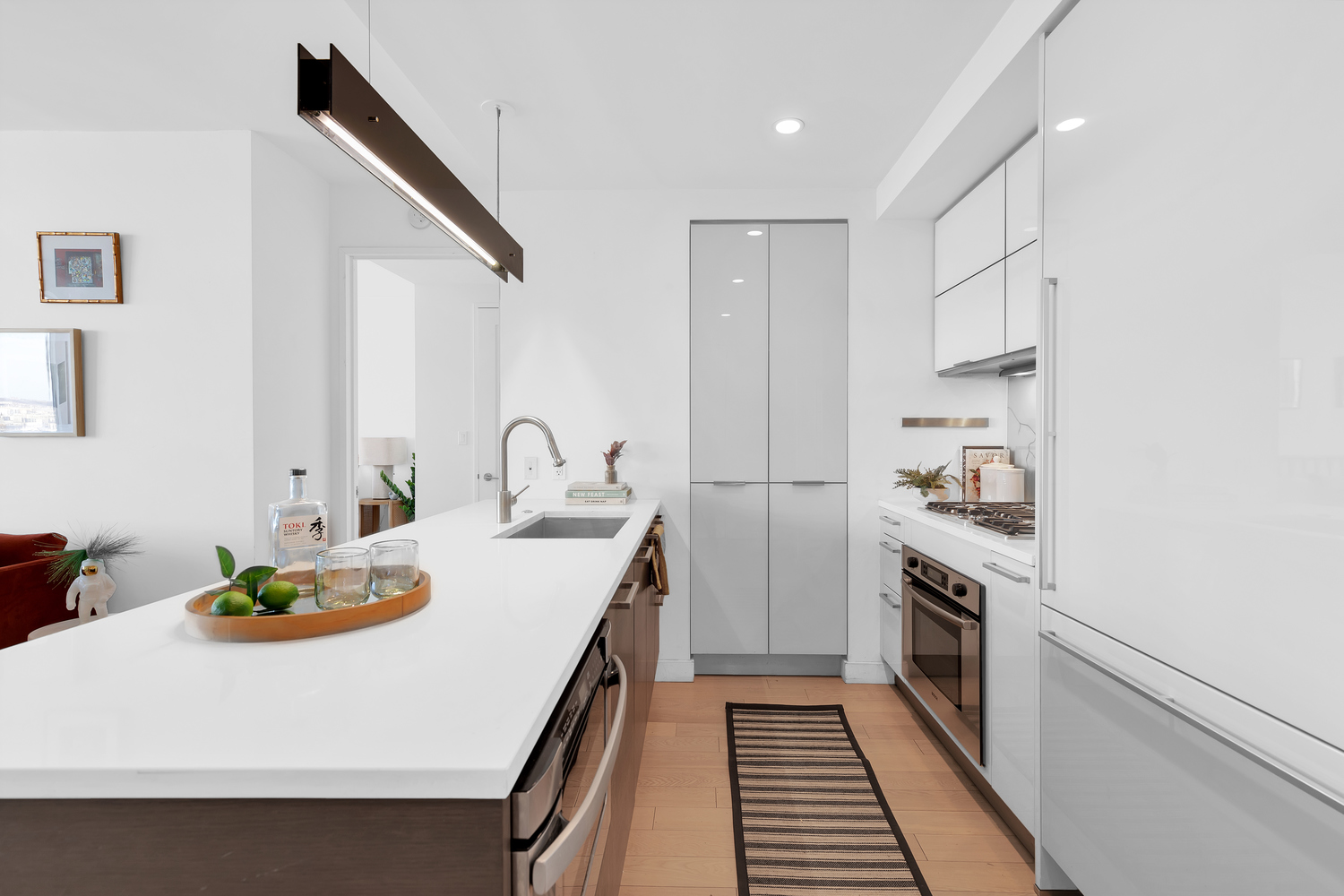 22 North 6th Street, Unit 18J Brooklyn, NY 11249 - Photo 4 of 18 a kitchen with a sink a stove and cabinets