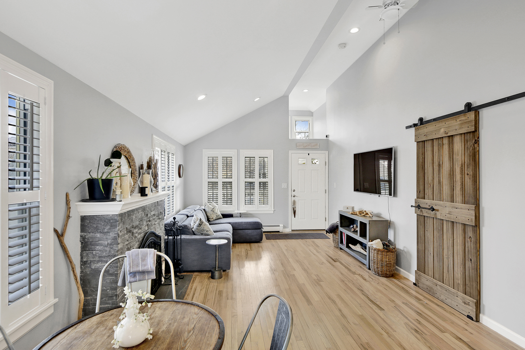 4-53 Beach 142nd Street Queens, NY 11694 - Photo 11 of 39 a living room with furniture a flat screen tv and a fireplace