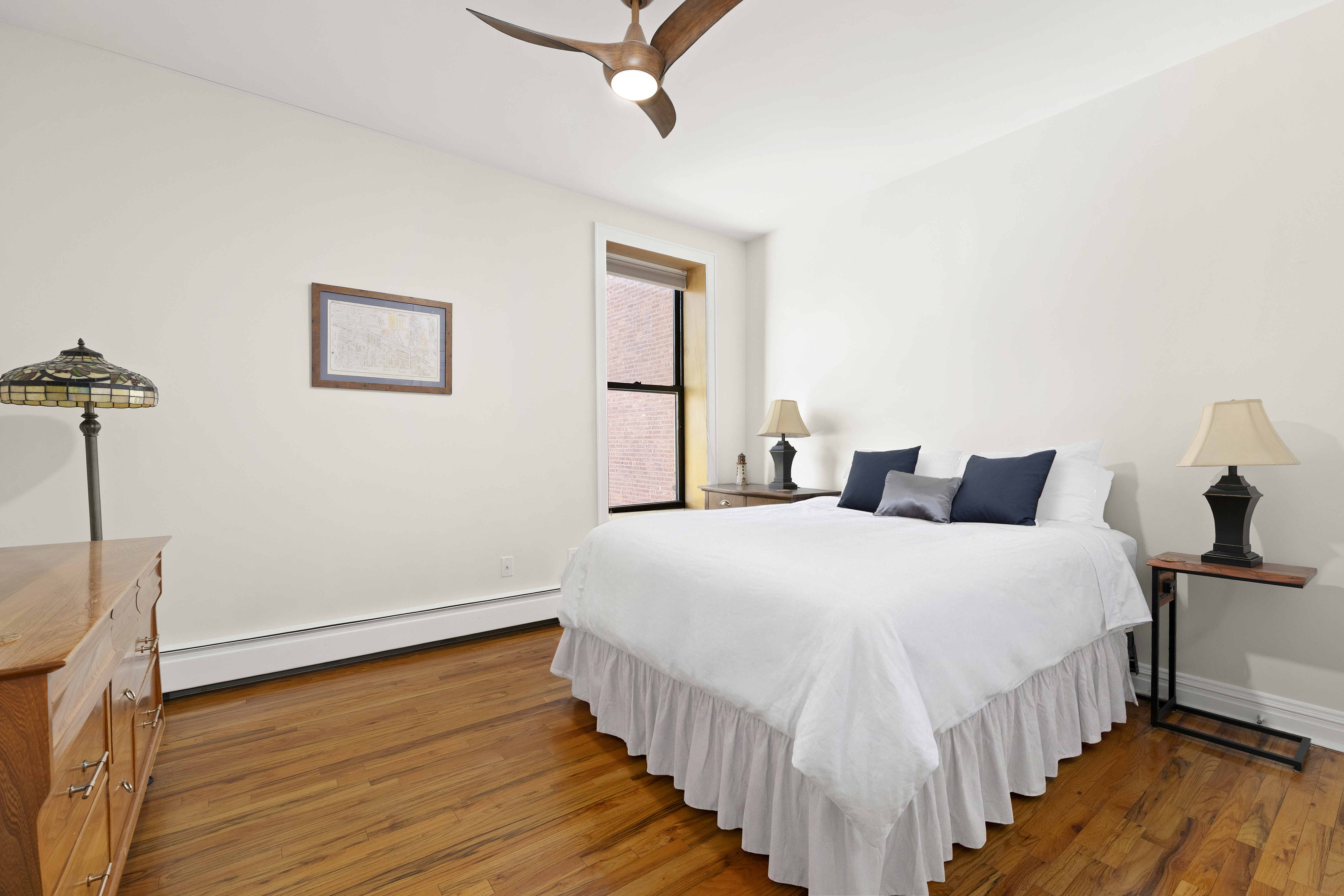 370 St Nicholas Avenue, Unit PH5B Manhattan, NY 10027 - Photo 8 of 12 a bedroom with bed and wooden floor