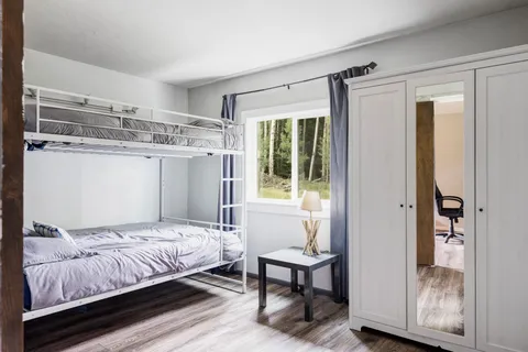 a bedroom with a bed and a window